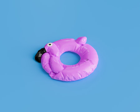 3D rendering of a deflated pink flamingo pool float isolated against a solid blue background, summer preparation concept.の写真素材