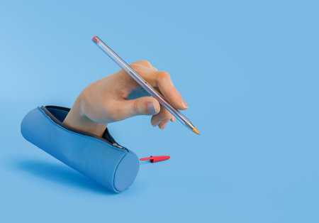 A hand holding a pen emerging from a blue pencil case, set against a blue background. Concept of creativity and surrealism. 3d renderingの写真素材