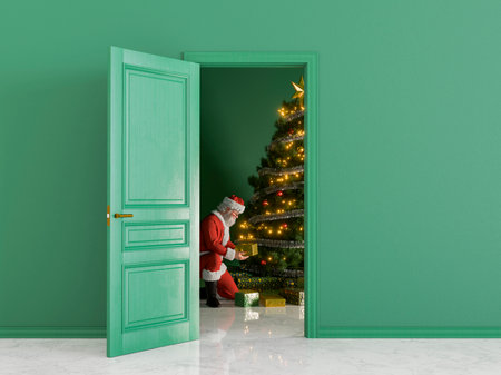 Santa Claus is placing Christmas gifts under a decorated tree in an empty room with green walls. 3d renderingの写真素材