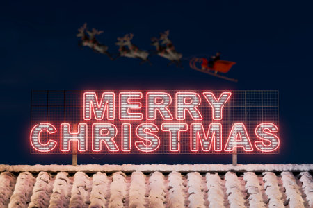 Merry christmas neon sign glowing at night with santa claus and his reindeer flying over a snowy roof. 3d renderingの写真素材