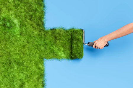Hand using paint roller painting green grass on a blue wall, representing spring and renewal. 3d renderingの写真素材