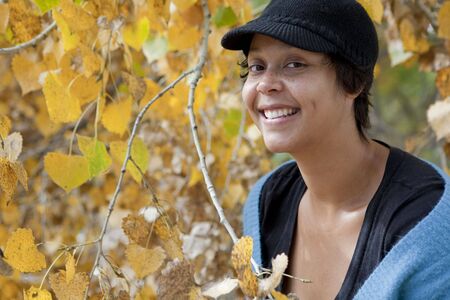 Portrait of a smiling, freckled, light skinned black womanの写真素材