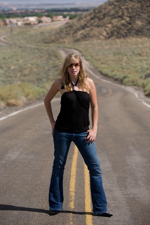 Hot young woman standing in middle of the rural streetの写真素材