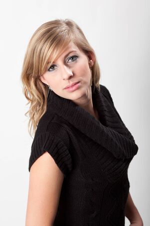 Headshot of beautiful blonde woman in the studio, wearing blackの写真素材