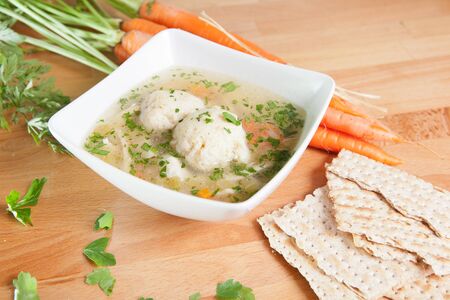 Matzah Ball Soup with carrots and Matzo breadの写真素材