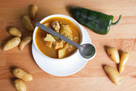 Green chile stew garnished with a Poblanos pepper and fingerling potatoesの写真素材