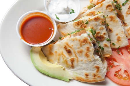 Plate of smoked salmon quesadillas with sour cream and red hot sauceの写真素材