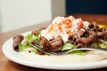 Close up look at lamb gyro and fork on a plateの写真素材