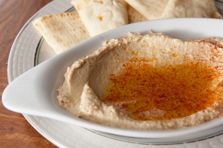 Bowl of hummus with olive oil and pita breadの写真素材