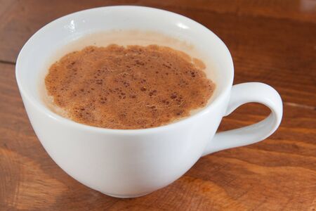 Cup of coffee or latte on a wooden tableの写真素材