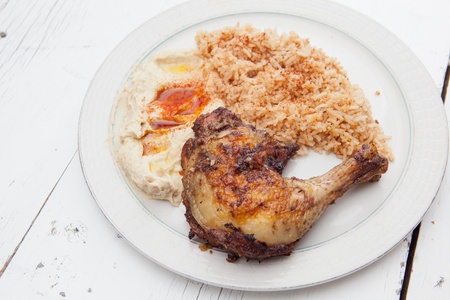 Plate of roasted chicken, saffron rice and hummusの写真素材