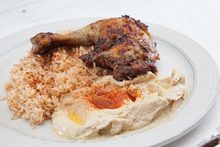 Plate of roasted chicken, saffron rice and hummusの写真素材