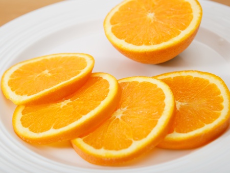 Plate of juicy and delicious sliced navel orangeの写真素材