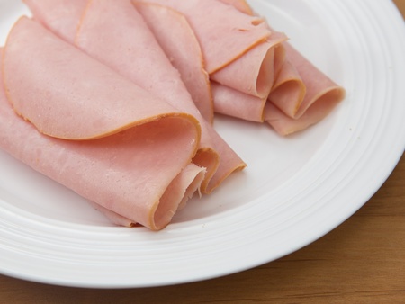 Plate of deli sliced smoked hamの写真素材