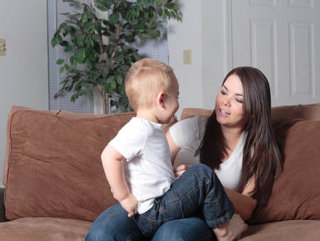 Young mother and son playing faces games with each otherの写真素材