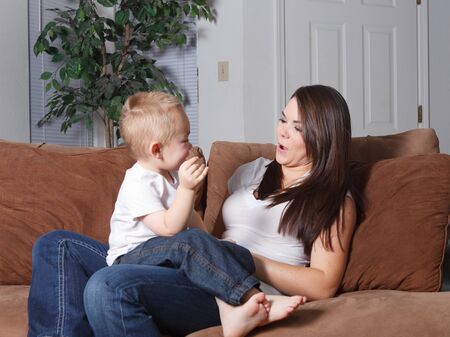 Toddler and mom playing games with faces and each otherの写真素材