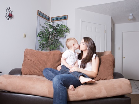 Brunette young mom and toddler son playing games at homeの写真素材