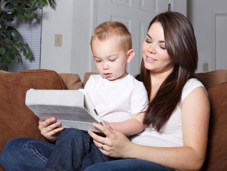 toddler and mom learning on computer wireless tabletの写真素材