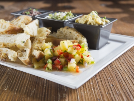 Appetizer plate with hummus, salsa, and beans
