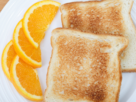 plain toast with citrus fruitの写真素材