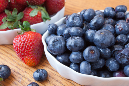 Bowl of blueberries close up with strawberriesの写真素材