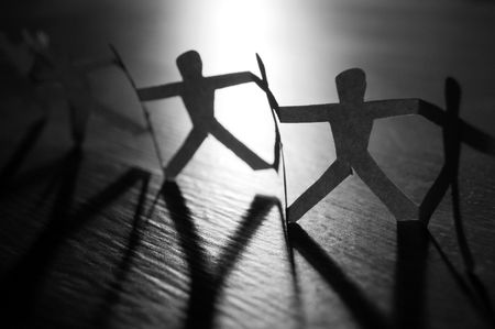 Conceptual photography with a chain of paper people.の写真素材