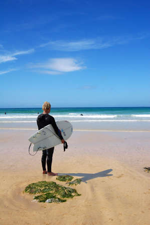 A surfer looking out to the waves.の写真素材