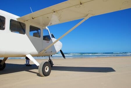 A light aircraft on a beach.