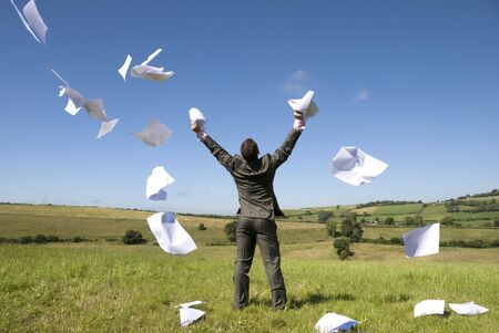 A happy businessman lets go of this paperwork! See my gallery for more.の写真素材