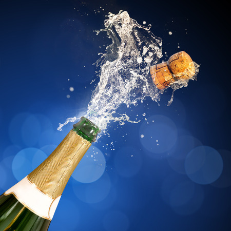 A champagne bottle popping open. Celebrations.の写真素材