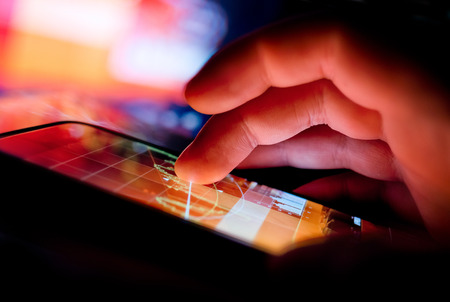 A Person using a portable device to display business data. Mobile Technology concept.