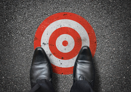 A businessman looking down at a target. Business concept.の写真素材
