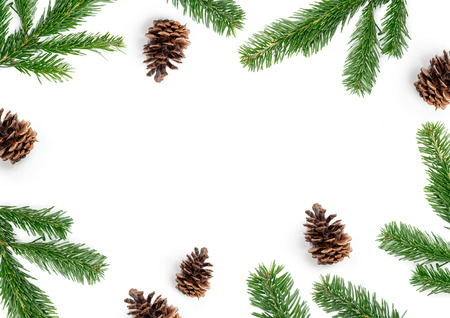 Merry Christmas layout composition, top view with fir tree branches and pine cones on a white...