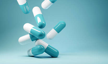 A group of antibiotic pill capsules fallling. Healthcare and medical 3D illustration background.の写真素材