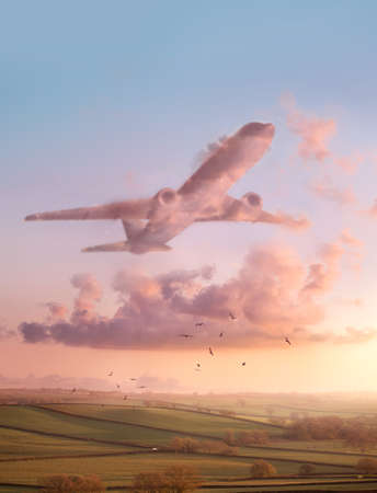 A sunset landscape scene with pink fluffy clouds in the shape of an airplane. Travel and flight conceptual Illustration.の写真素材