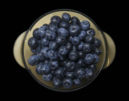 Healthy food fresh blueberries in a bowl on a black background. Photo food.の写真素材