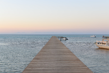 Wood bridge pier against beautiful sunset sky photoの写真素材
