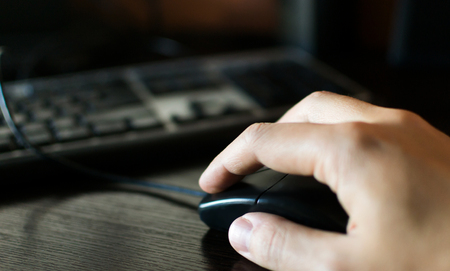 Freelance work at the computer hand on the mouse and keyboard. Download stock photo.の写真素材