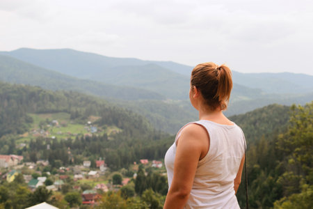 Beautiful woman among nature. Relaxation in the hills and forests. High in the mountains.の写真素材