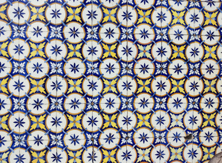 Ancient azulejo tiles on the wall of an old house in a Portuguese village.