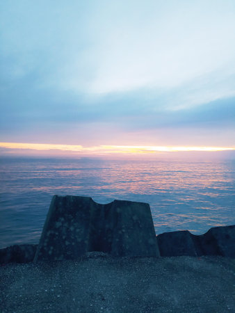 Beautiful sunset at the sea, amazing colors, light beam shining through the cloudscapeの写真素材