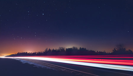 Long exposure of night city. Car motion trails on road. Speed light streaks background with blurred fast moving light effectの素材