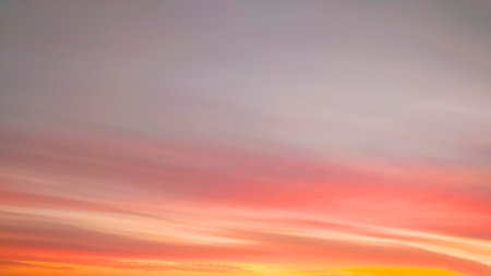 Panorama of the yellow sky with fancy clouds at sunset