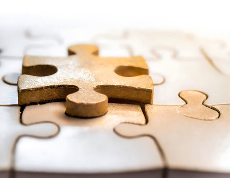 A detailed view of a single puzzle piece, showing its texture, color, and interlocking edges. The piece appears to be part of a larger puzzle, with visible hints of its surrounding design and pattern.の素材