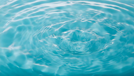Blue water in a pool creating ripples from movement or disturbance, reflecting light and creating patterns on the surface.の素材