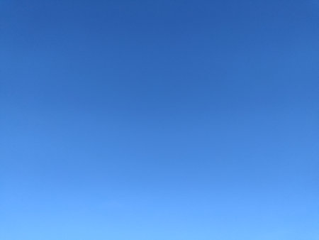 Clear blue sky texture and white fluffy cloud nature background. The sun shines bright in the daytime in summer, meteorology. Soft sunlight on panoramic image. Heaven, peace concept and copy space. Peaceful and tranquil atmosphere.の写真素材