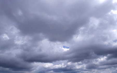 Clear blue sky texture and white fluffy cloud nature background. The sun shines bright in the...