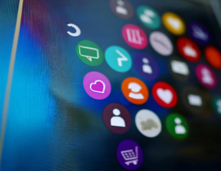 Close up image of social media icons on a screen, representing online interaction, digital communication, and social networking.の素材