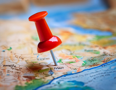 Close up image of a marker pointing to a specific location on a map, representing geographic positioning and site identification.の素材