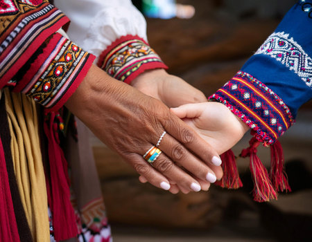 Close up image of a parent and child holding hands, symbolizing family bond, caregiving, and nurturing relationship.の素材